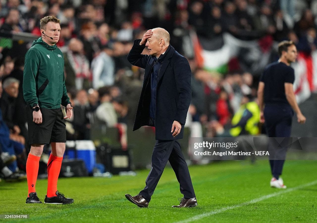Referee Oleksandr Kalonov in the green UEFA kit standing on the touchline during Rayo Vallecano vs Lech Poznań in Madrid.